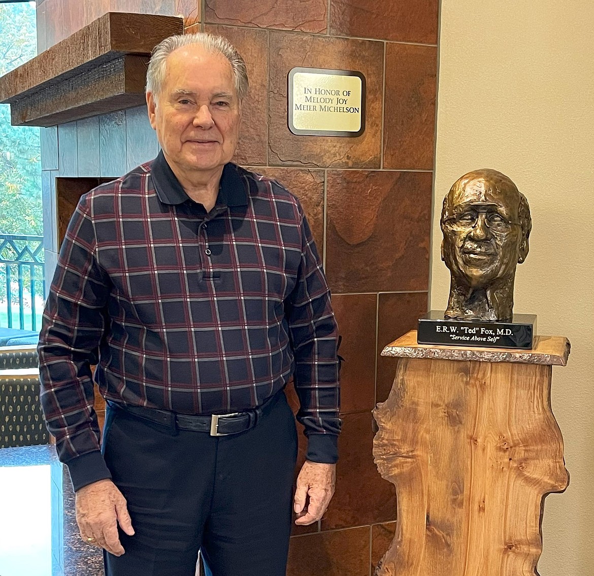 Sculptor Bryan Ross of Sagle at the library with his Ted Fox bust.