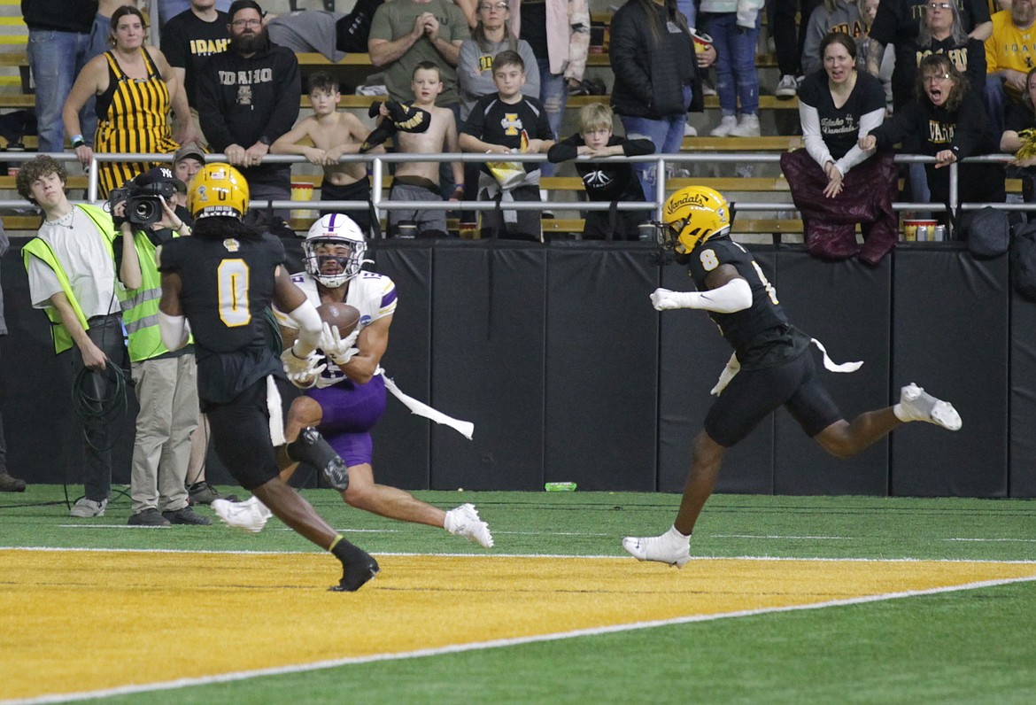 MARK NELKE/Press
Brevin Easton of UAlbany caught three touchdown passes in Saturday's 30-22 win at Idaho in the FCS quarterfinals at the Kibbie Dome in Moscow — including this go-ahead score in the fourth quarter between Vandal defenders Murvin Kenion III (0) and Ormanie Arnold (8).