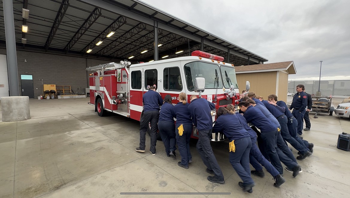 Columbia Basin Technical Skills Center fire science students follow a fire service tradition and push their fire engine into its new home.