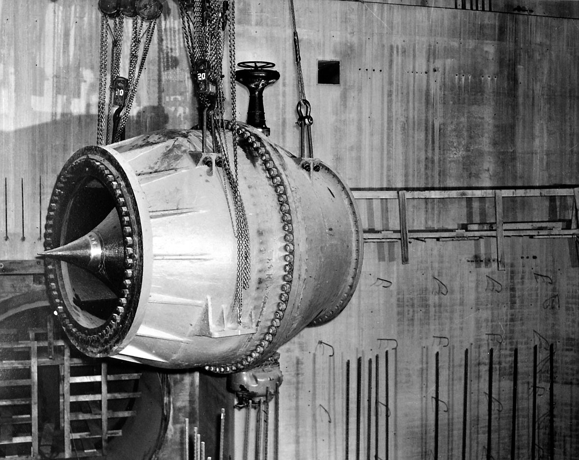 A turbine component, a “needle valve,” is lowered into place in Grand Coulee Dam’s east powerhouse in 1944.