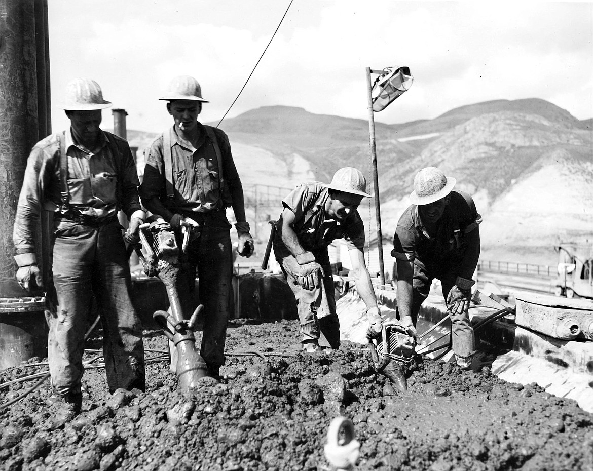 Construction workers at Grand Coulee Dam work concrete in 1938.