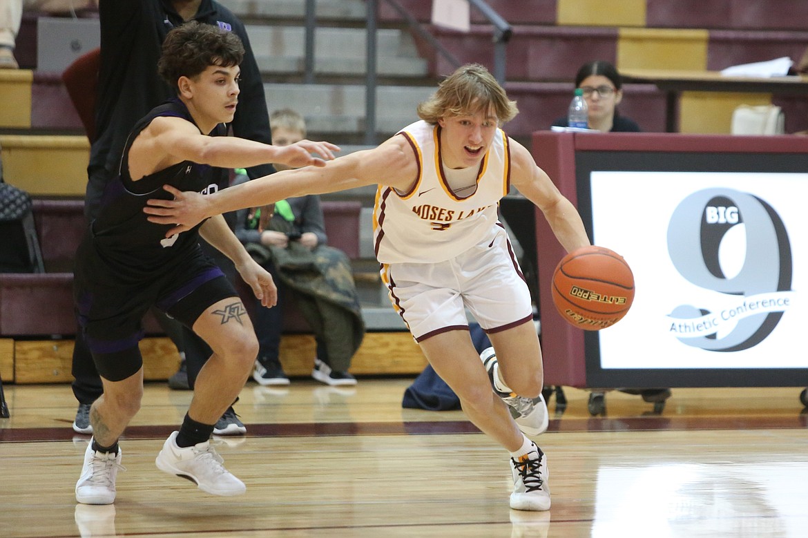 Moses Lake sophomore Brady Jay, in white, gets past a Pasco defender in the second quarter.