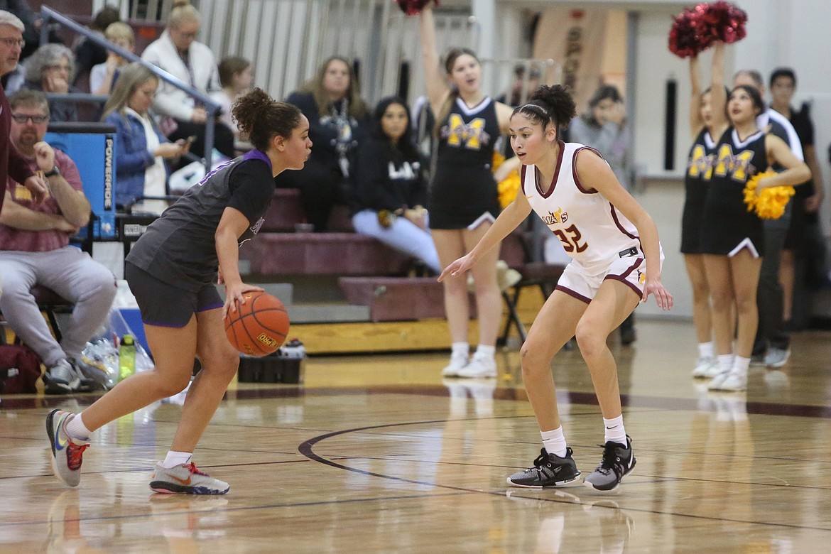 Moses Lake junior Madison Bond (11) defense a Pasco player in the first half.