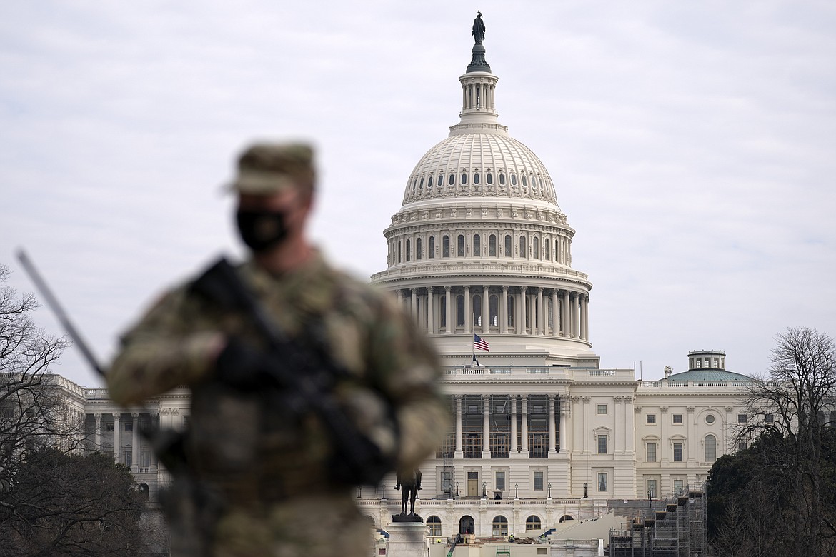 A member of the National Guard patrols the area outside of the U.S. Capitol at the Capitol in Washington, Wednesday, Feb. 10, 2021. The House passed a defense policy bill Thursday, Dec. 14, 2023, that authorizes the biggest pay raise for troops in more than two decades, overcoming objections from some conservatives concerned the measure did not do enough to restrict the Pentagon's diversity initiatives, abortion travel policy and gender-affirming health care for transgender service members. (AP Photo/Jose Luis Magana, File)