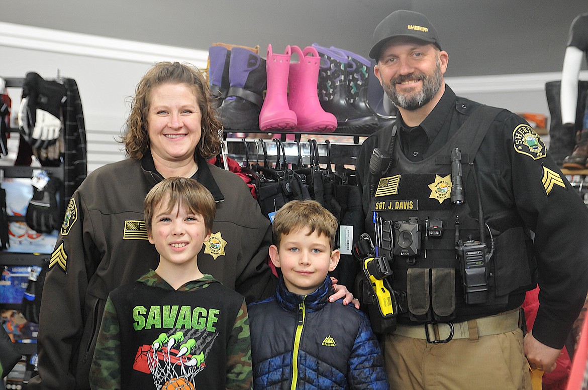 John and Jennifer Davis took Micah and Cedar Christmas shopping at the stores on Mineral Avenue in Libby during the annual Shop with a Cop event on Dec. 14 in Lincoln County. (Hannah Chumley/The Western News)