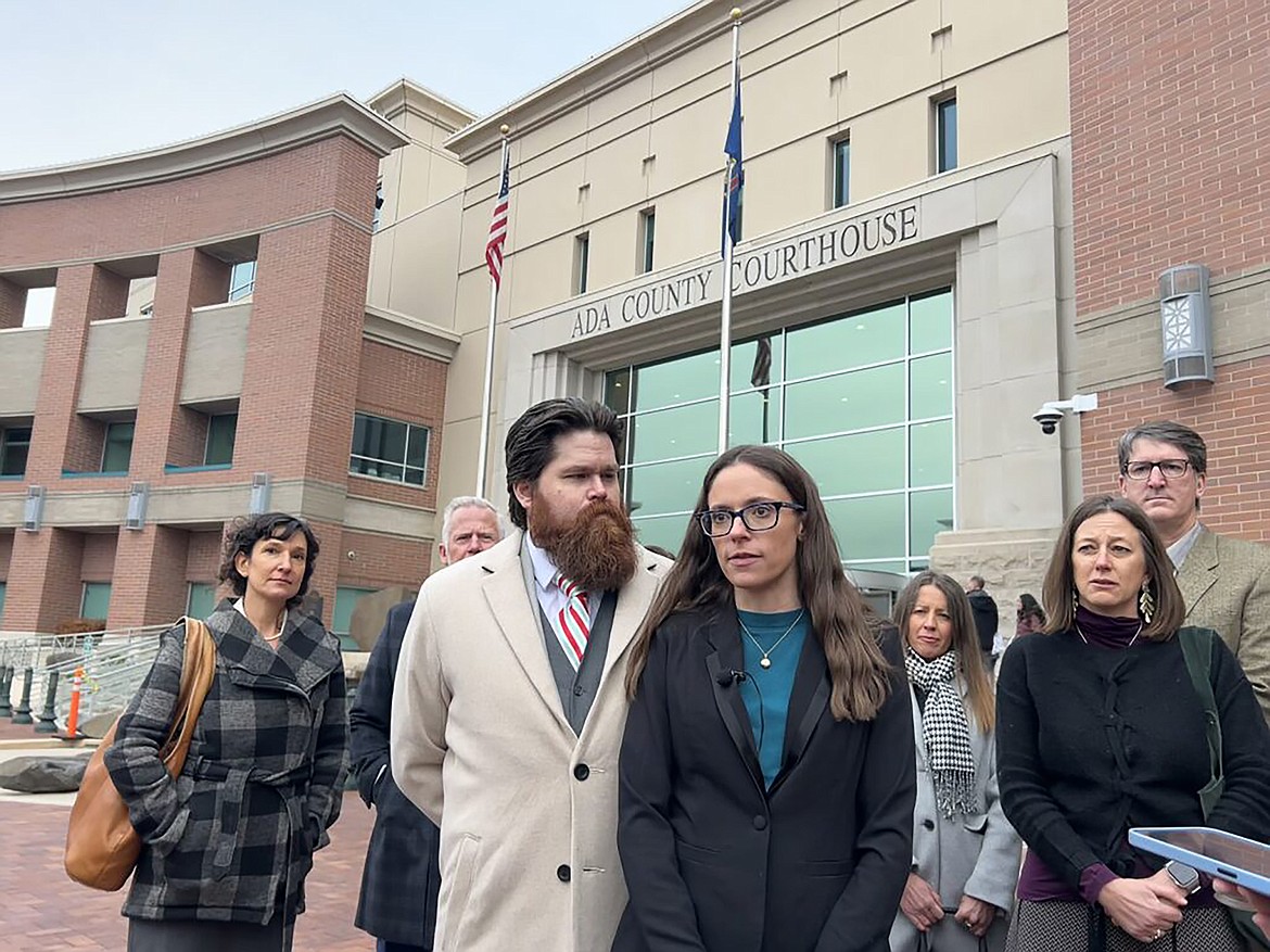 John and Jennifer Adkins (center) stand in front of the Ada County Courthouse after a hearing in response to the state’s motion to dismiss their lawsuit challenging the scope of the medical exceptions in the state’s abortion ban. The lawsuit, Adkins v. Idaho, was filed in September after Adkins had to seek an abortion in Oregon because Idaho has a near-total ban on abortions without exceptions provided to preserve the health of the pregnant patient, only to prevent their death.