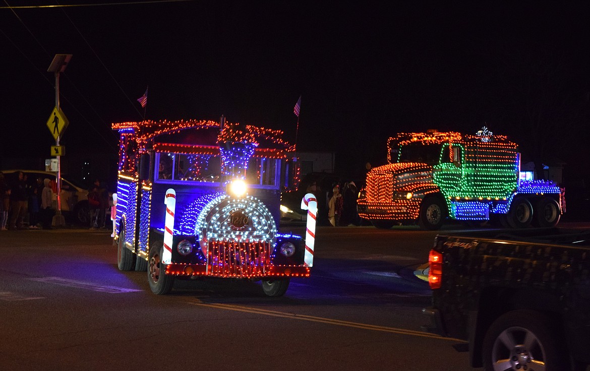 Two vehicles from the Lower Valley Christmas Trucks group turn from Government Road onto Boundary Avenue during the December 8 2023 Mattawa Christmas parade.