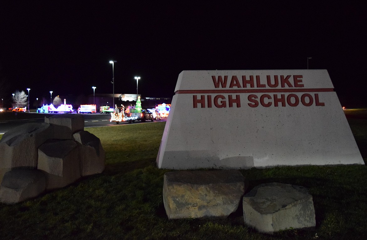 Parade vehicles and floats line up in front of Wahluke High School, where the 2023 parade ended and the Living Nativity Project was being held.