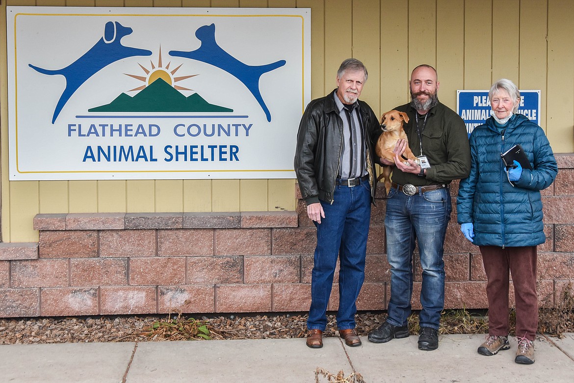 From left to right, Colin Johnson, Austin Hicks and Myni Ferguson stand at the Flathead County Animal Shelter holding The Grinch, the puppy. Johnson recently donated $50,000 to the shelter. (Kate Heston/Daily Inter Lake)