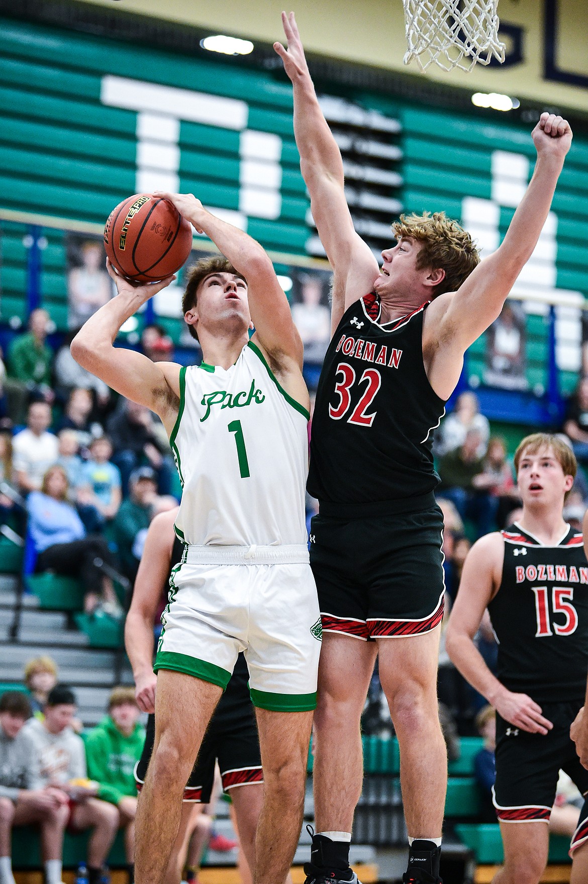 Glacier's Cohen Kastelitz (1) looks to shoot under the basket against Bozeman's Quaid Ash (32) in the first quarter at Glacier High School on Friday, Dec. 15. (Casey Kreider/Daily Inter Lake)