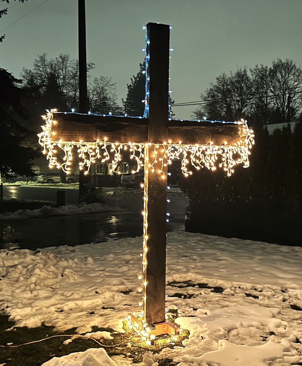 A lighted cross brightens the front of a house that is part of The Way Home CDA recovery program.