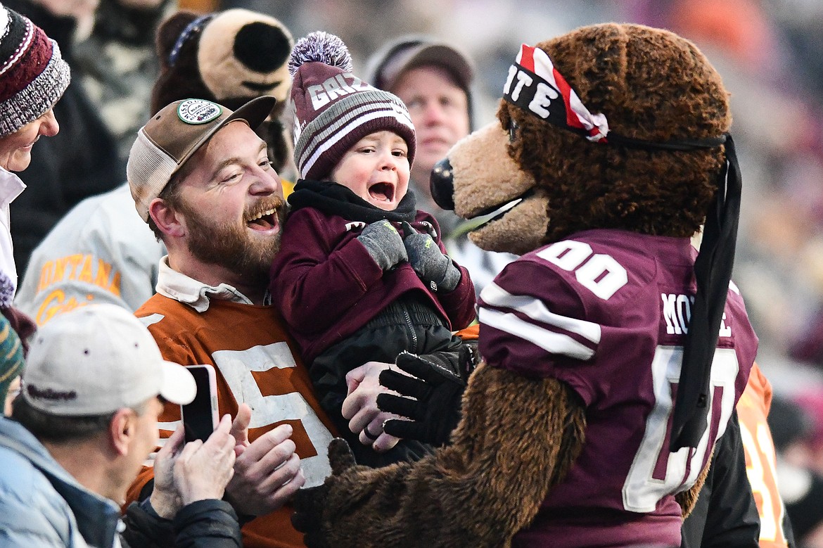 A young Griz fan meets Monte in the stands as Montana faced off against North Dakota State in the FCS semifinals at Washington-Grizzly Stadium on Saturday, Dec. 16. (Casey Kreider/Daily Inter Lake)