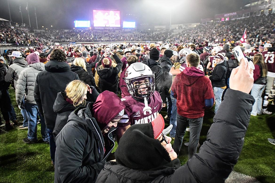 Grizzlies cornerback Corbin Walker (8) takes a selfie with fans on the field after he intercepted a pass in overtime against North Dakota State in the FCS semifinals at Washington-Grizzly Stadium on Saturday, Dec. 16. (Casey Kreider/Daily Inter Lake)(