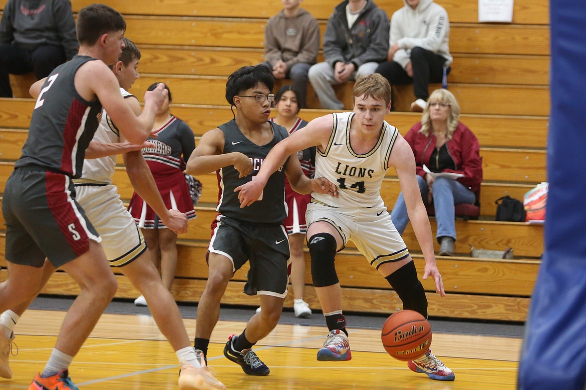 MLCA/CCS sophomore James Robertson (24) moves with the ball under the rim against Waterville-Mansfield Friday.