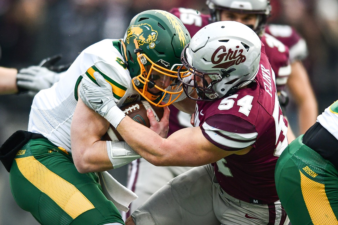 Grizzlies linebacker Tyler Flink (54) tackles North Dakota State quarterback Cole Payton (9) on a run in the first quarter of an FCS semifinal at Washington-Grizzly Stadium on Saturday, Dec. 16. (Casey Kreider/Daily Inter Lake)