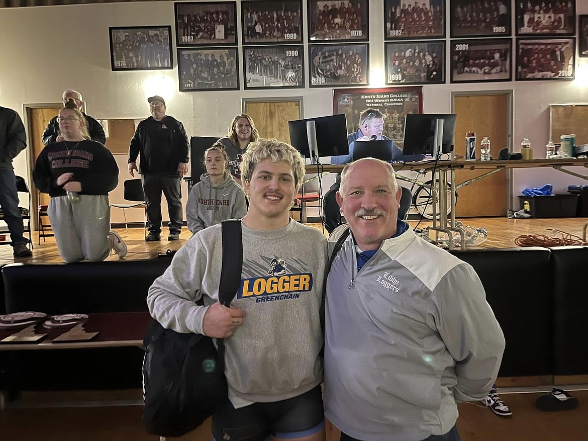 Libby's Jace DeShazer and Loggers head coach Dean Thompson celebrate the senior's championship at 195 pounds Saturday at North Idaho College in Coeur d'Alene. (Photo courtesy Libby High School)
