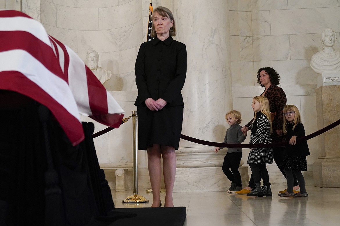 People arrive during the public repose for retired Supreme Court Justice Sandra Day O'Connor in the Great Hall at the Supreme Court in Washington, Monday, Dec. 18, 2023. O'Connor, an Arizona native and the first woman to serve on the nation's highest court, died Dec. 1 at age 93. Former law clerks of O'Connor stand at left and right. (AP Photo/Jacquelyn Martin)