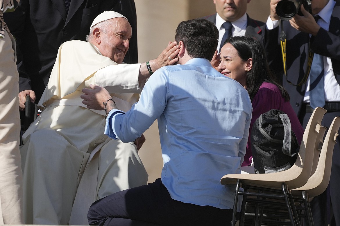 Newly couples of weds meet with Pope Francis during the weekly general audience in St. Peter's Square at the Vatican, on Oct. 11, 2023. Pope Francis has formally approved allowing priests to bless same-sex couples, with a new document released Monday Dec. 18, 2023 explaining a radical change in Vatican policy by insisting that people seeking God’s love and mercy shouldn’t be subject to “an exhaustive moral analysis” to receive it. (AP Photo/Gregorio Borgia, File)