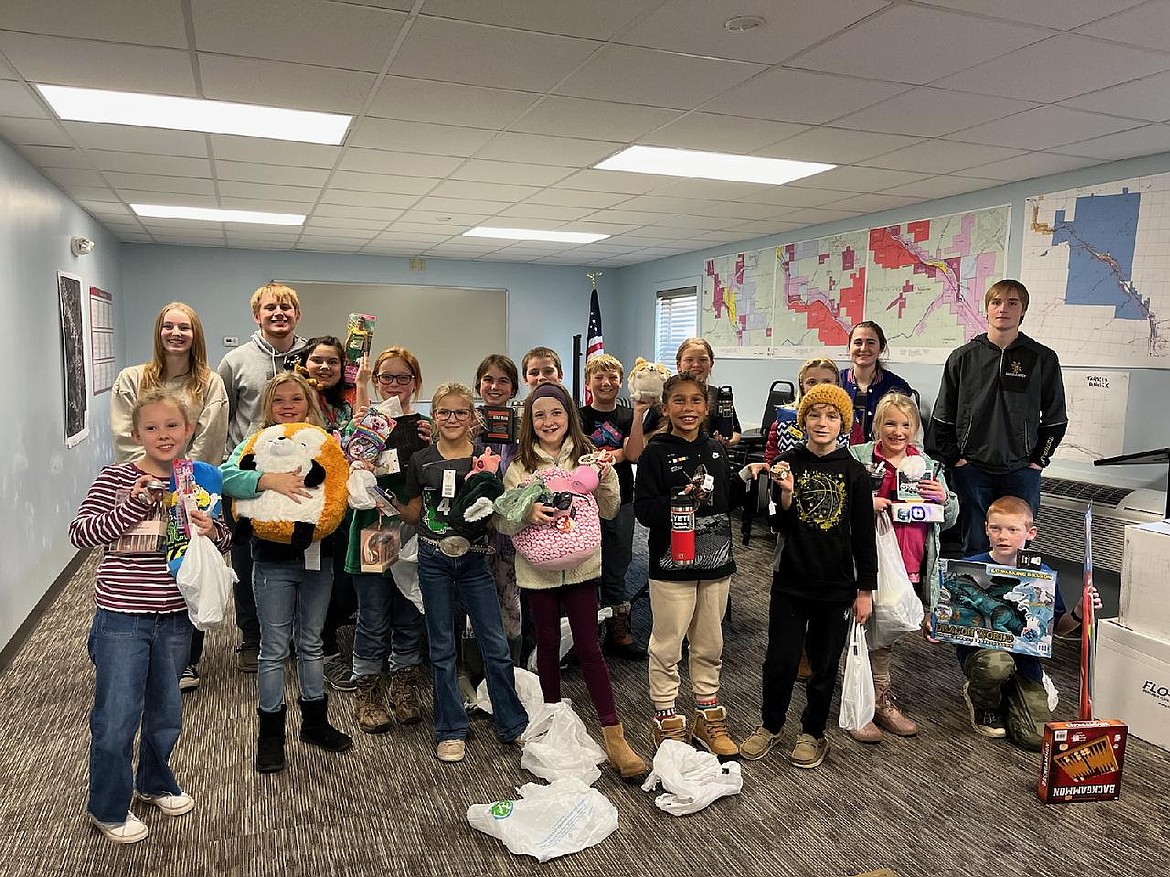 Stacy Crabb’s sixth-grade class at Superior Elementary hold gifts that will be donated for Christmas. (Photos provided)