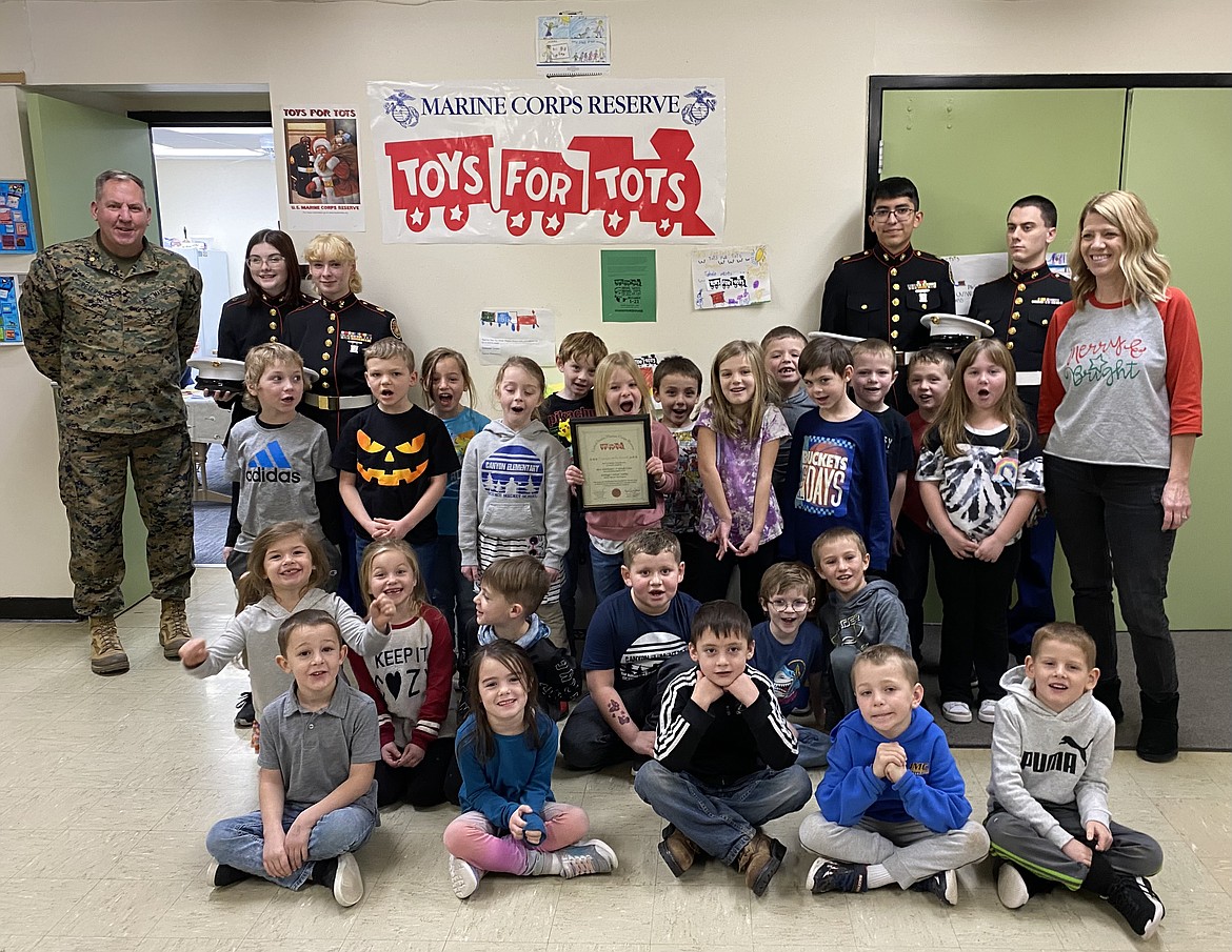 Adelynn, Alijah, Billy, Brantlee, Braydon, Connor, Ellie, Evie, Frankie, Harry, Jack, Kade, Kellin, Liam, Miles, Pierlee, Ruby, Rylan, Sawyer, Tucker, Weston, Wylee, Whitley, and Dismas hold up their certificate for collecting gifts for Toys for Tots as part of their first-grade class with Jackie Durham.
Major Craig Petersen, of Kellogg JROTC stopped by Canyon Elementary School Monday morning with JROTC students Zoie Lawson, Tessa Hodgeman-Ricter, and Mattix Harris.