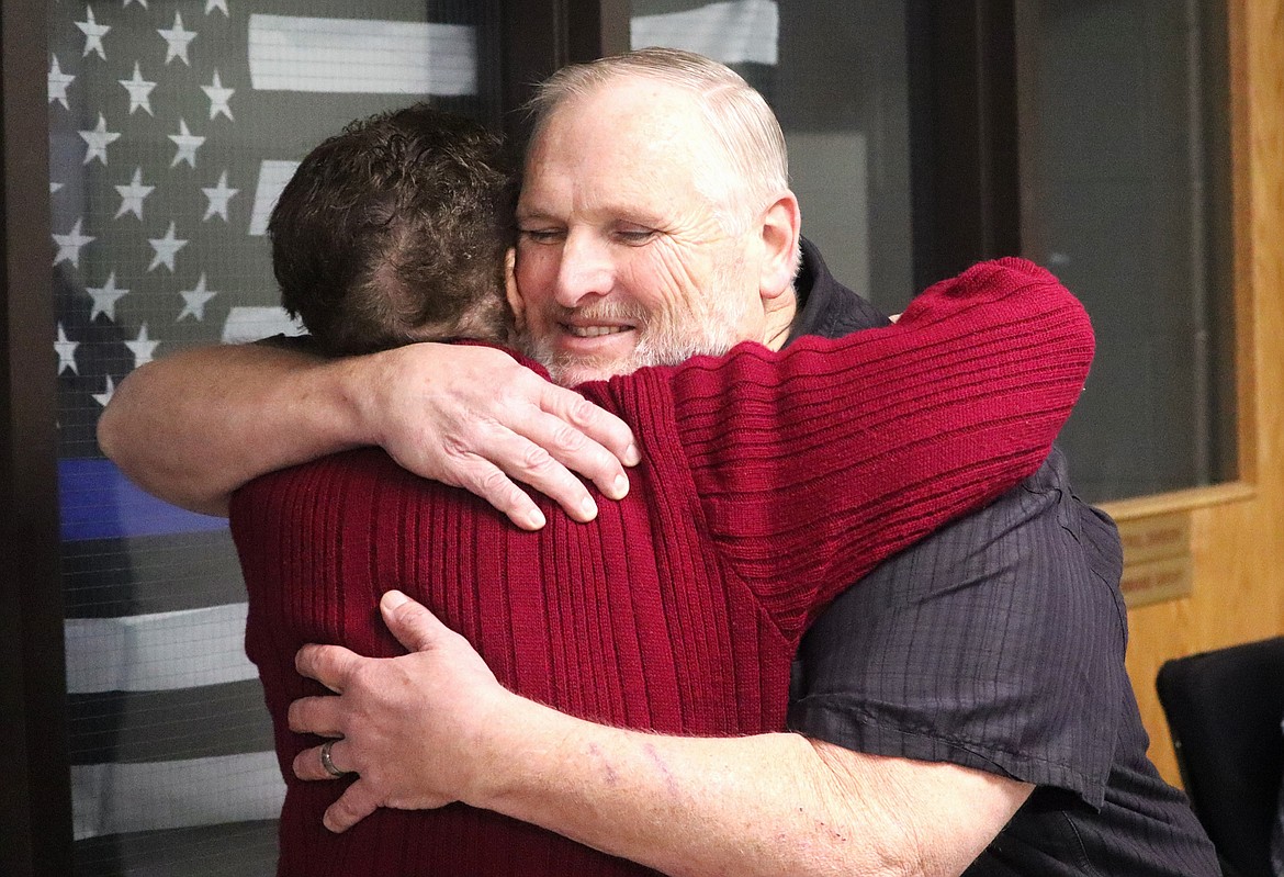 Ed Jacobs gives Sharron Barkley a hug during their retirement celebration Monday at the Kootenai County Sheriff's Office.