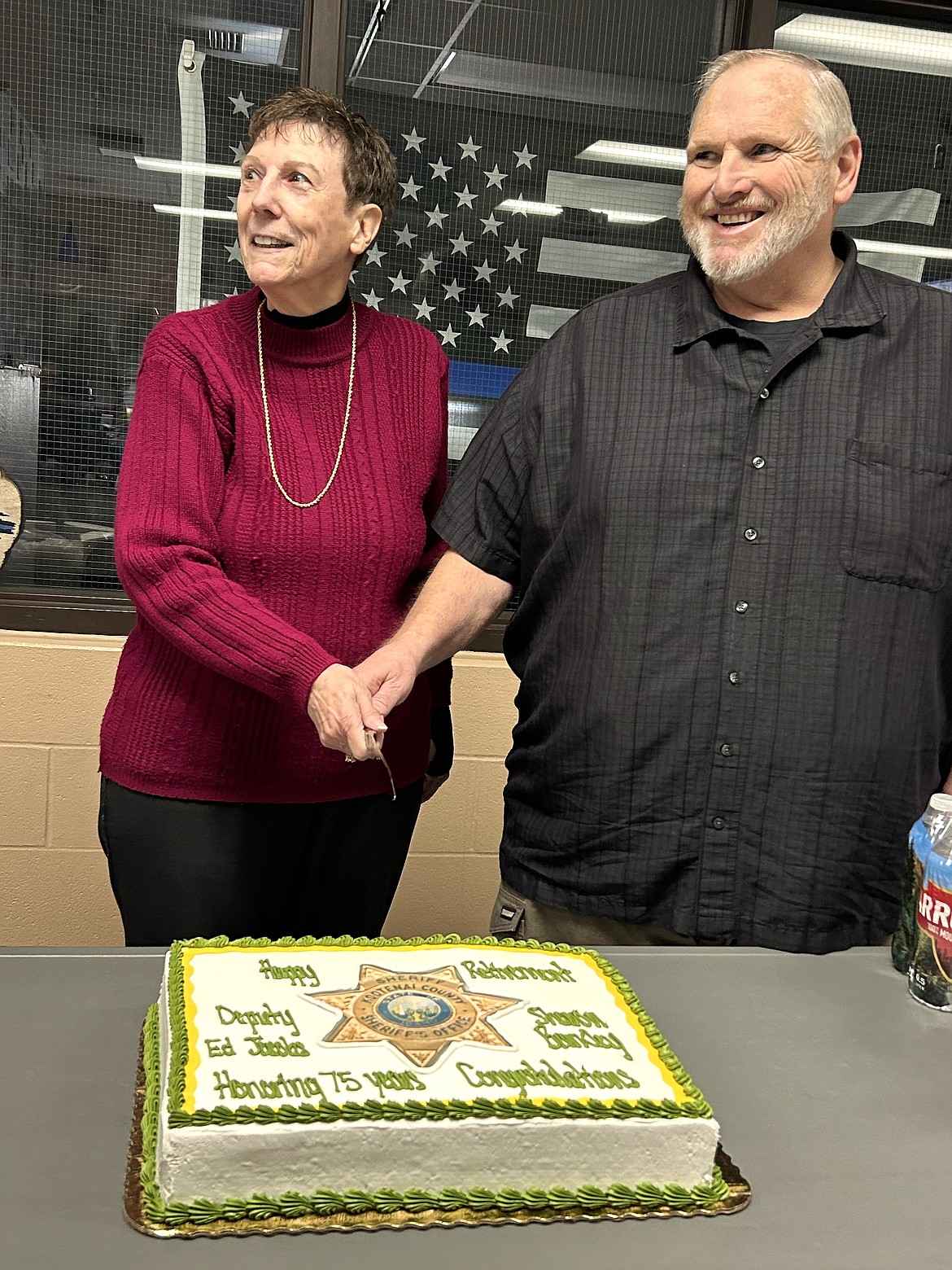 Kootenai County Sheriff's Office retirees Ed Jacobs and Sharron Barkley cut the cake during their retirement celebration Monday.