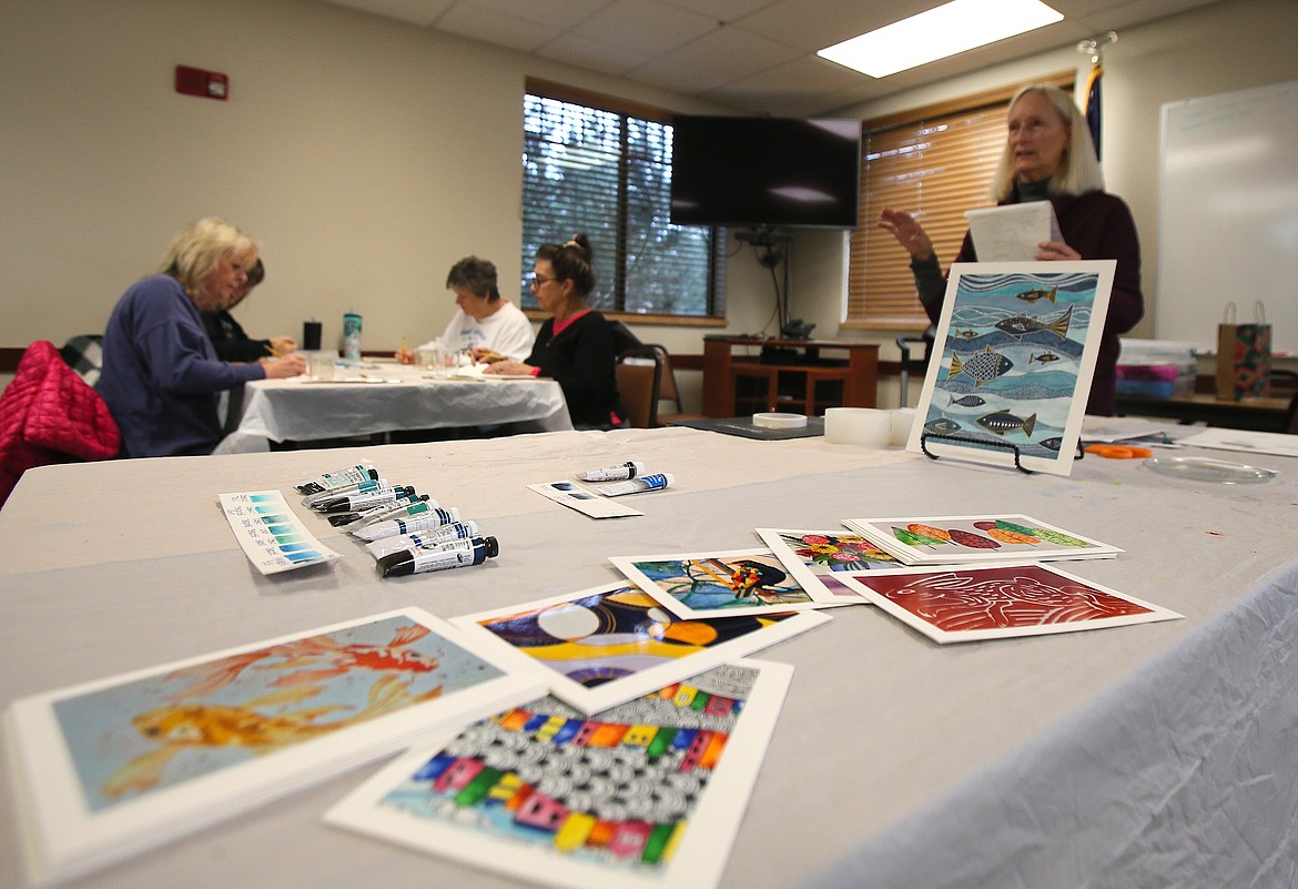 Colorful prints of artwork are seen Thursday as retired art instructor Tama Meyer instructs fellow retired educators on their new artistic assignment during an EngAGE Artfully class in Coeur d'Alene.