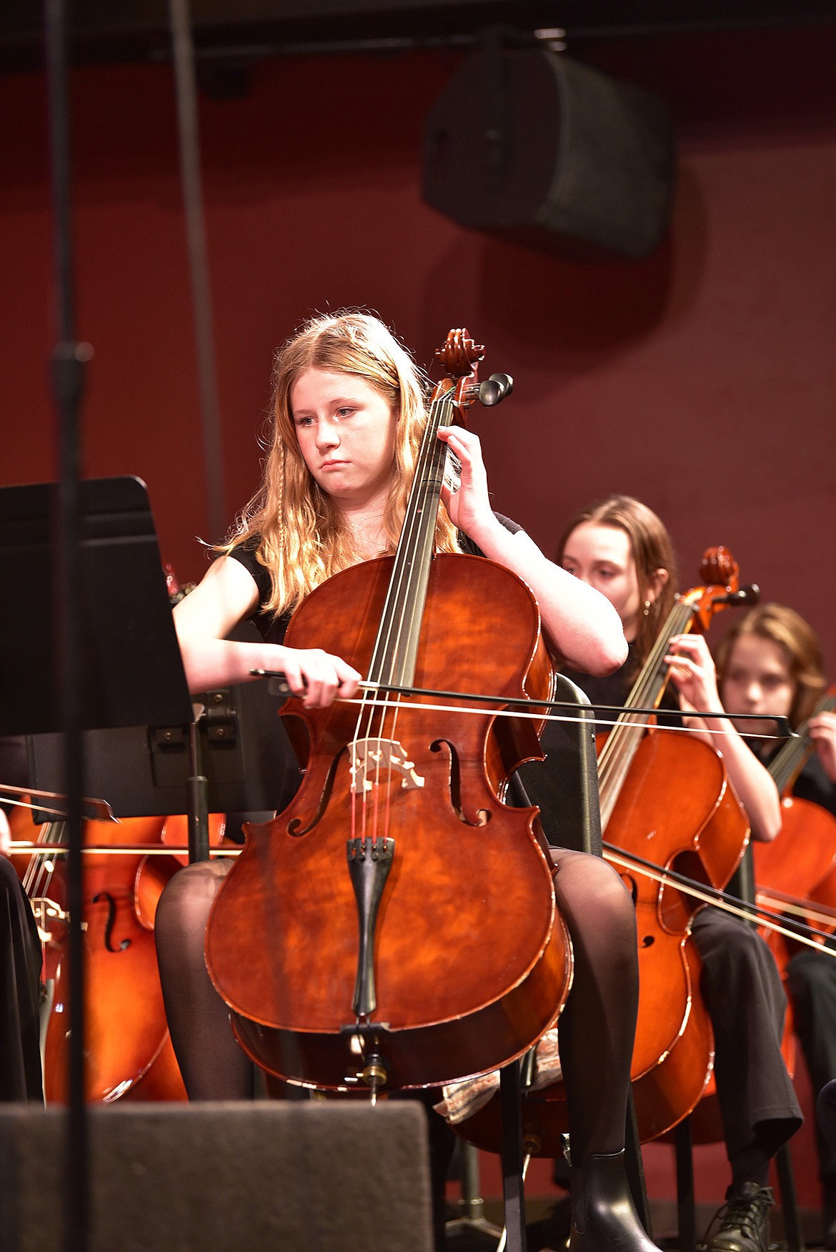 Eighth grader Madelynn Jonson plays the cello with the orchestra at its concert last week. (Julie Engler/Whitefish Pilot)