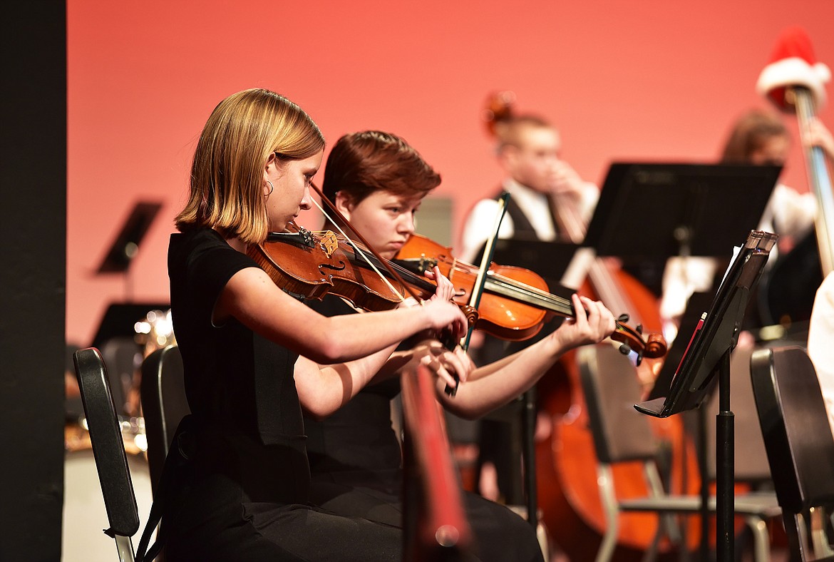 Sophomores Solvei Gunderson and Syrcie Johnson, violinists for the WHS orchestra, played at the winter concert. (Julie Engler/Whitefish Pilot)