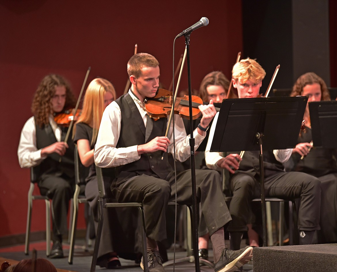 Seniors Carson Krack and Jackson Dorvall play violin for the WHS orchestra. (Julie Engler/Whitefish Pilot)