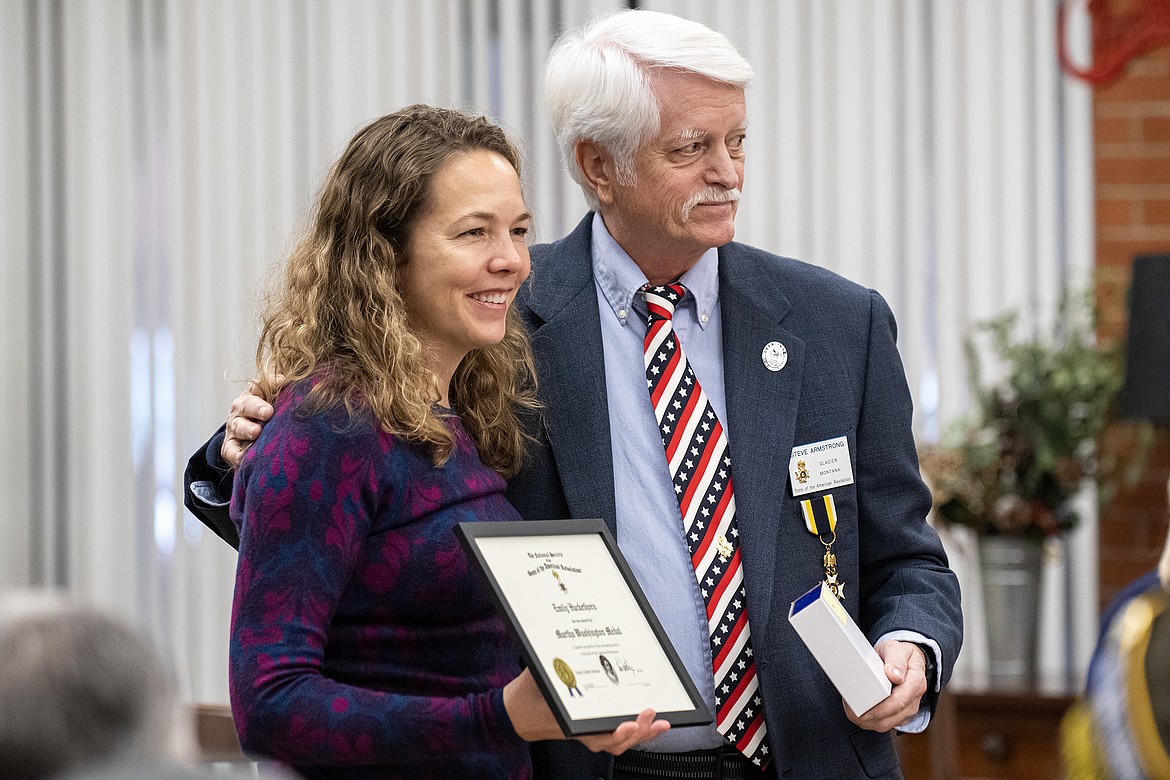 Emily Hackethorn accepts the Sons of the American Revolution Martha Washington Medal from Glacier Chapter President Steve Armstrong during the Wreaths Across America event at Montana Veterans Home on Saturday, Dec. 16. Also honored for their service to the veteran community were Denise Holm and Lori Alsbury. (Avery Howe photo)