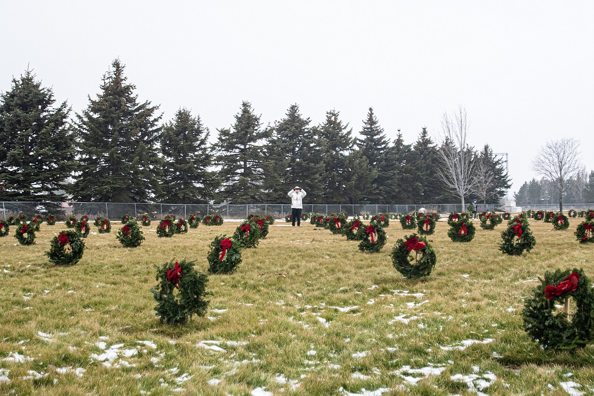 Kathryn Price stops to take a photo of all of the wreaths placed in Montana Veterans Home Cemetery by Wreaths Across America volunteers on Saturday, Dec. 16. (Avery Howe photo)