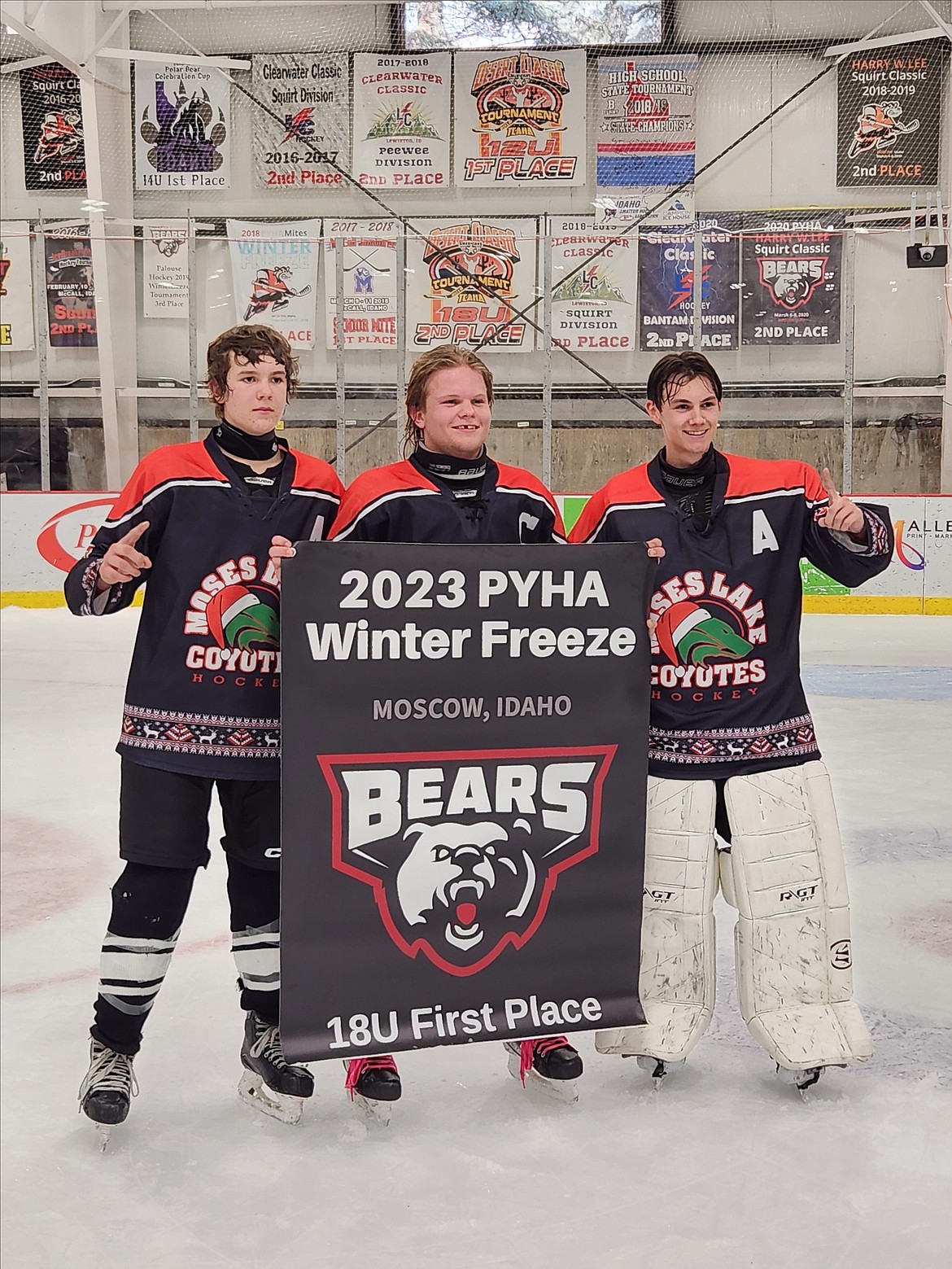 Moses Lake’s Travis Shearer, left, Noah Burns, center, and Wyatt Horst, right, smile with the first-place banner at last weekend’s Palouse Winter Freeze Tournament in Moscow, Idaho.