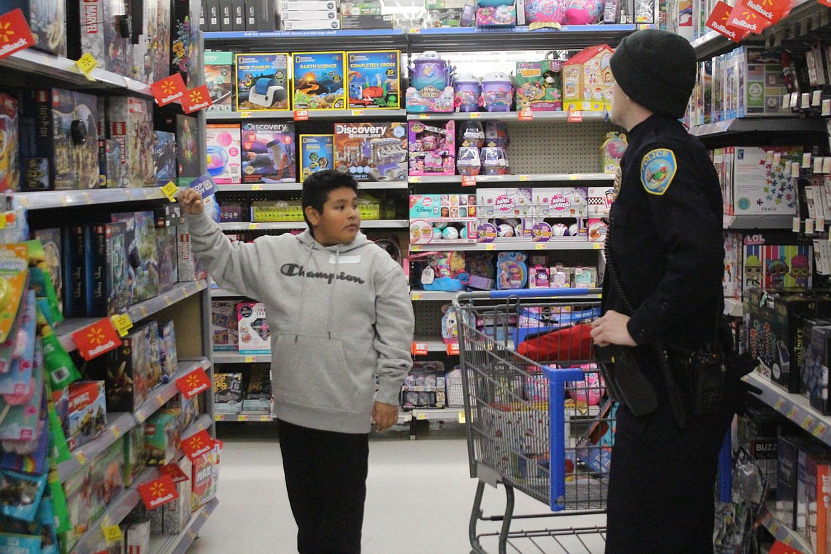 Othello Police Officer Denny Brock, right, and his shopping buddy Christopher try to decide among the options.