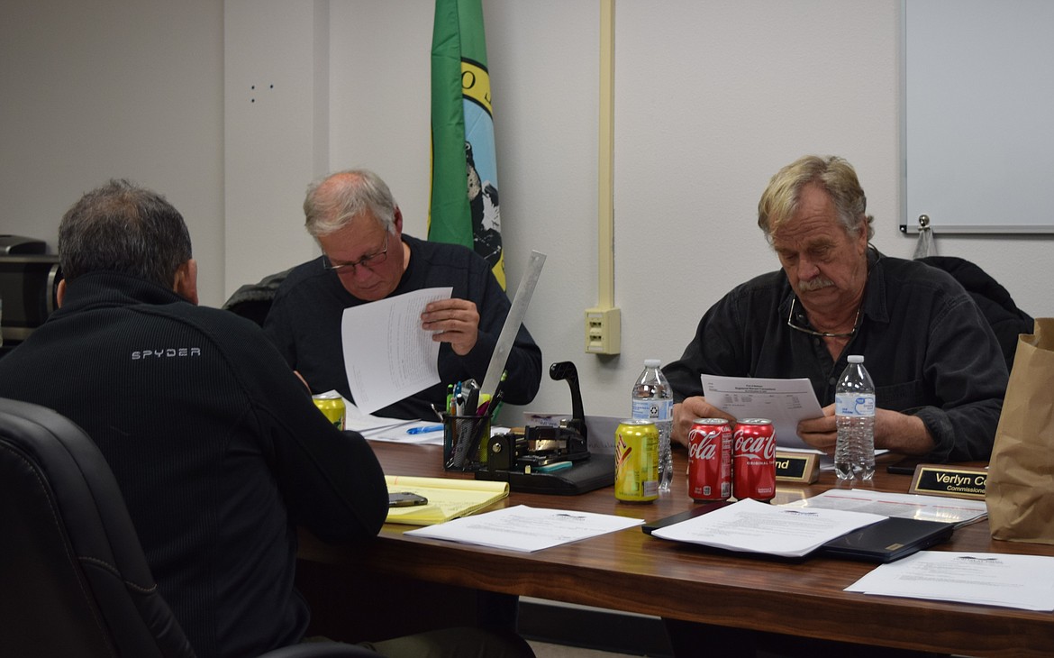 Port of Mattawa Commissioners Lauri Dayton, left, and Glenn Leland, right, look over port documents during the regular meeting Monday evening at the port’s offices. The meeting featured updates on several of the port’s ongoing projects.