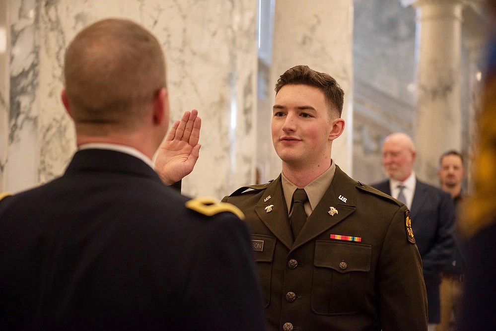 Brig. Gen. Ryan Robinson administers the oath of commissioning to his son, 2nd Lt. Benjamin Robinson, Dec. 15 at the Idaho State Capitol in Boise. Robinson commissioned in the same location in May 1996.