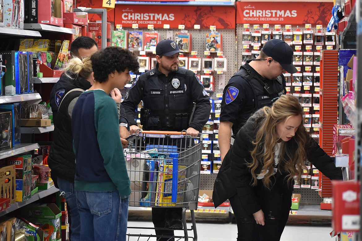 There were lots of officers available to help the families pick out gifts and other necessities at Walmart Monday night for the Shop With a Cop event.