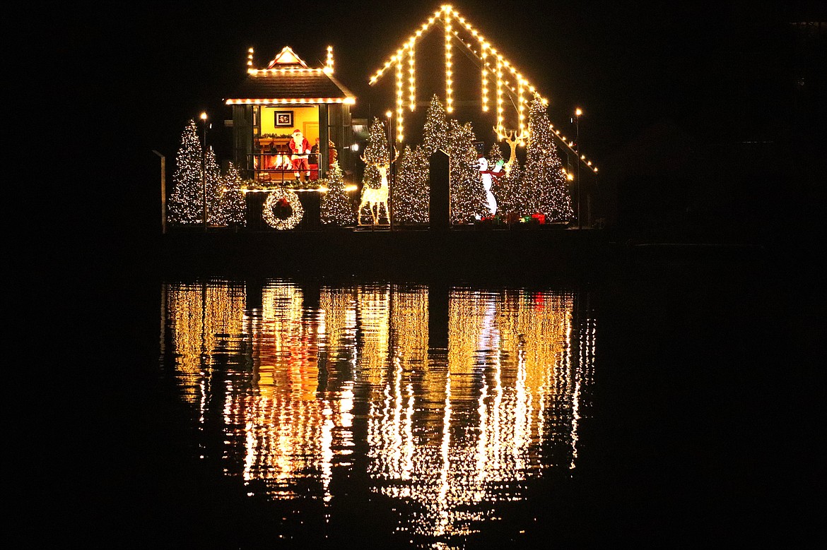 Lights reflect in Lake Coeur d'Alene as Santa greets visitors on a Journey to the North Pole with Lake Coeur d'Alene Cruises from his new home on Tuesday. "Santa's New North Pole and lamp house feature has been a long time coming for us and is a true labor of love for our team,” said Carl Fus, Lake Coeur d'Alene Cruises general manager.