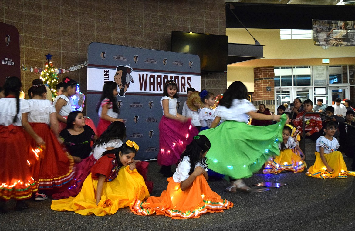 Local youth dancers with lights sewn into their dresses dance across the stage in the commons of Wahluke High School during the Mattawa Winter Festival Dec. 14.