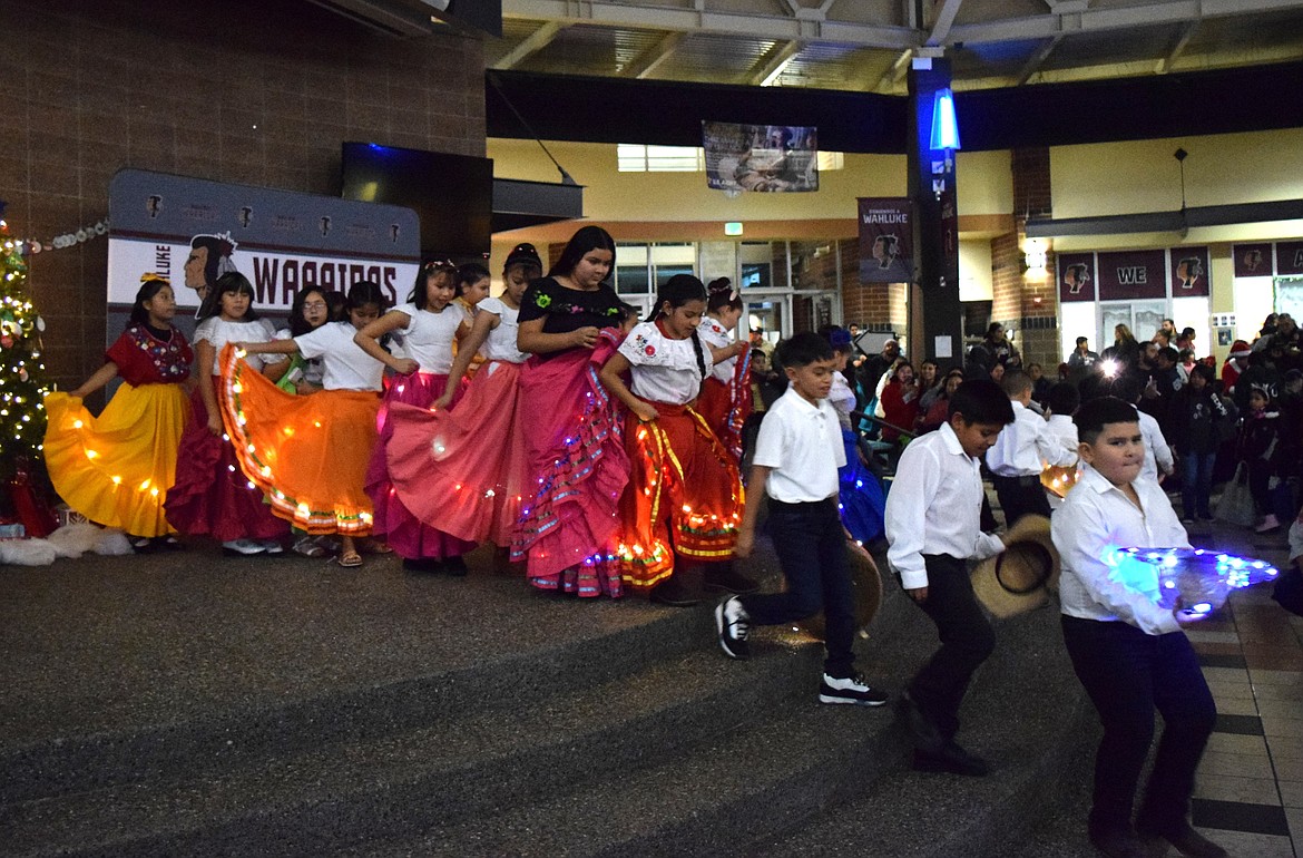 Local youth dancers make their way down the steps from the Wahluke High School commons stage to walk through the audience.