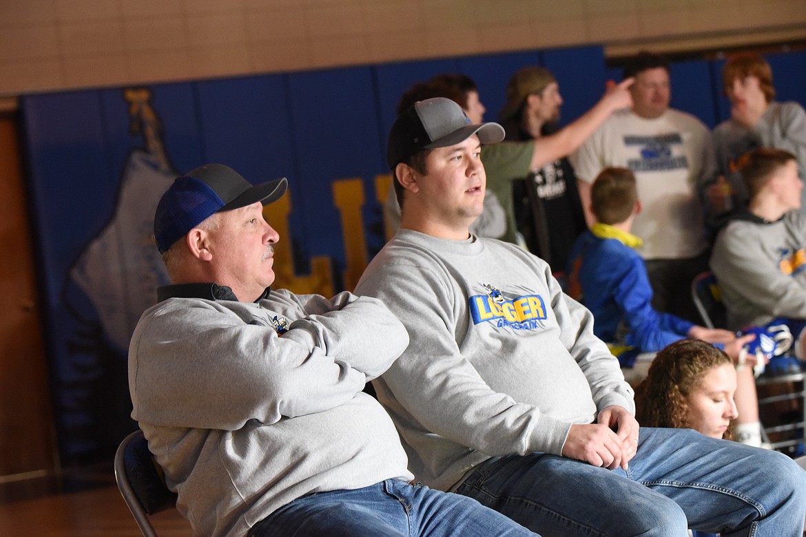 Libby wrestling coaches Dean Thompson and Justin Graham watch a match on Tuesday, Dec. 19, in Libby. (Scott Shindledecker/The Western News)