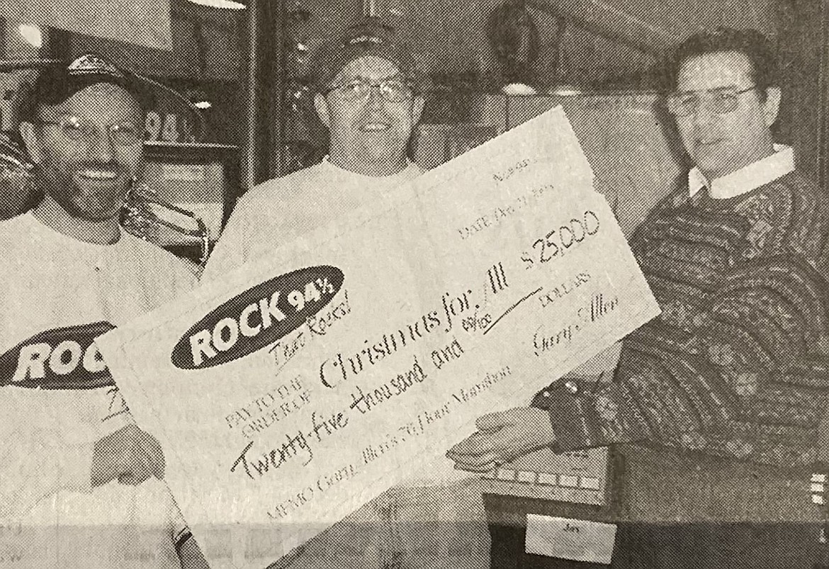 From left, Bruce Deming and Gary Allen present a check for $25,000 to The Press editor Mike Feiler after Gary’s 1998 marathon.