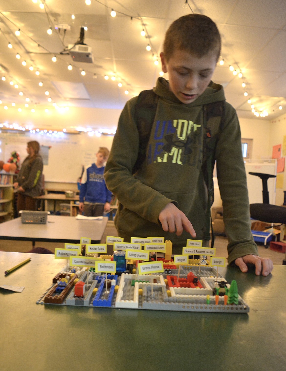 Levi Drake points out the Army base as he explains the setup of his space colony using a LEGO design. Fifth graders were expected to plan the space for colonies in space thinking about current technology and the future possibilities of technology. Math was also included in some of the problem-solving that went into the designs.