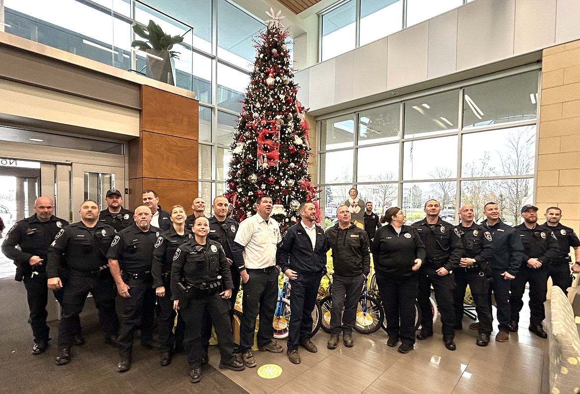 Les Schwab employees and Coeur d'Alene police staff pose after delivering toys to Kootenai Health on Wednesday.