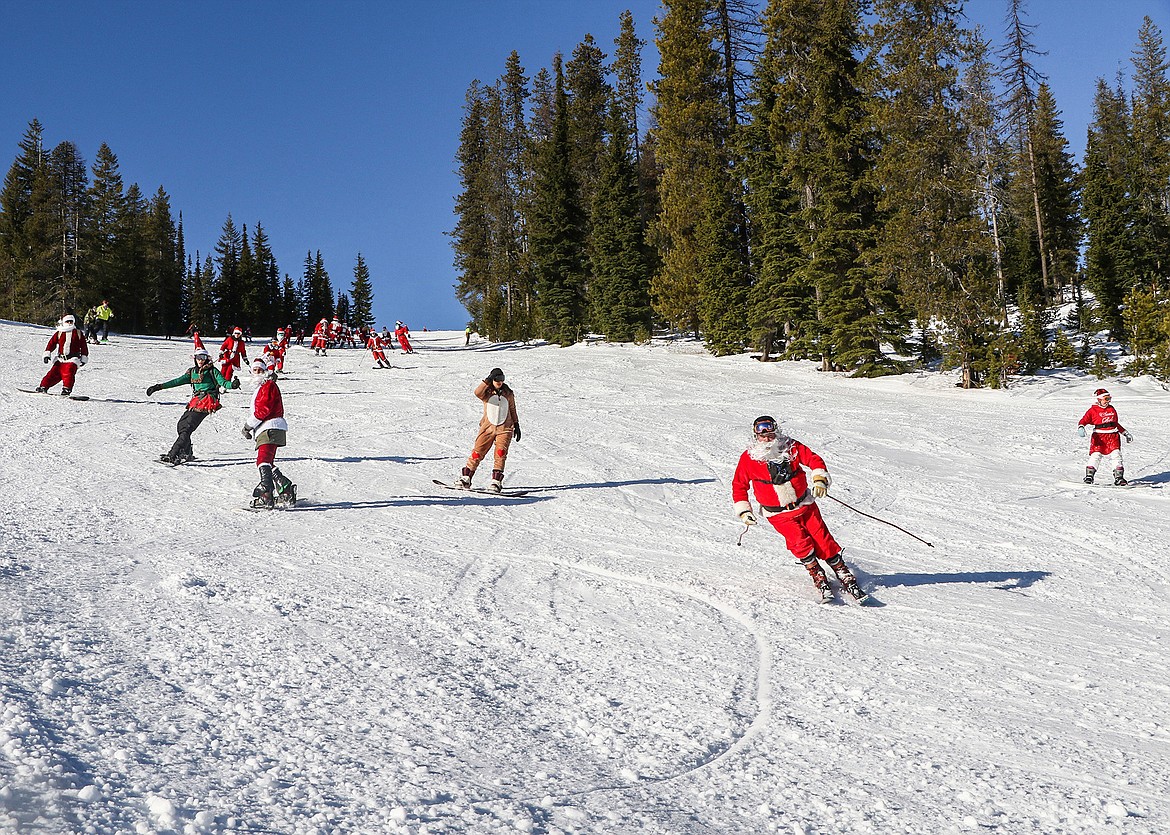 Santas shred the hills at Lookout Pass in 2020. Anyone dressed as Santa can purchase a lift ticket at Lookout Pass for only $20 Saturday.