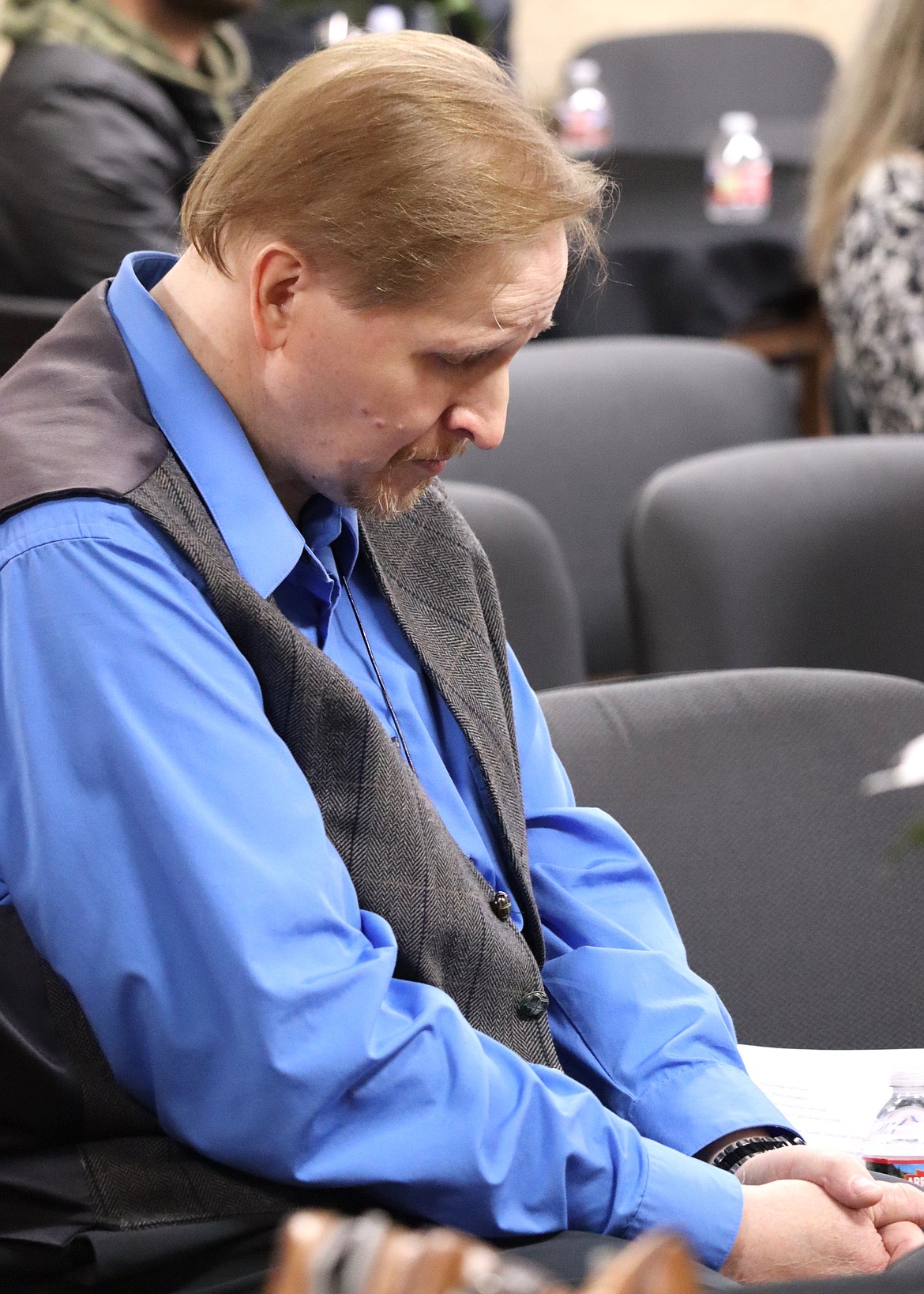 Chris Green bows his head in prayer during the National Homeless Persons Memorial Day vigil on Thursday in Coeur d'Alene.