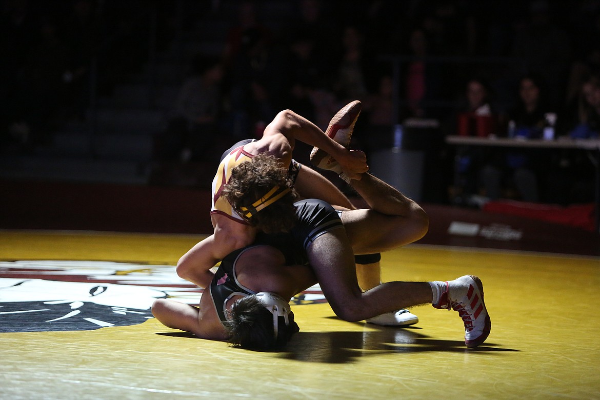 Moses Lake junior Drayden Gaither, top, won by an 11-0 decision over Othello senior Marcos Zuniga, bottom.