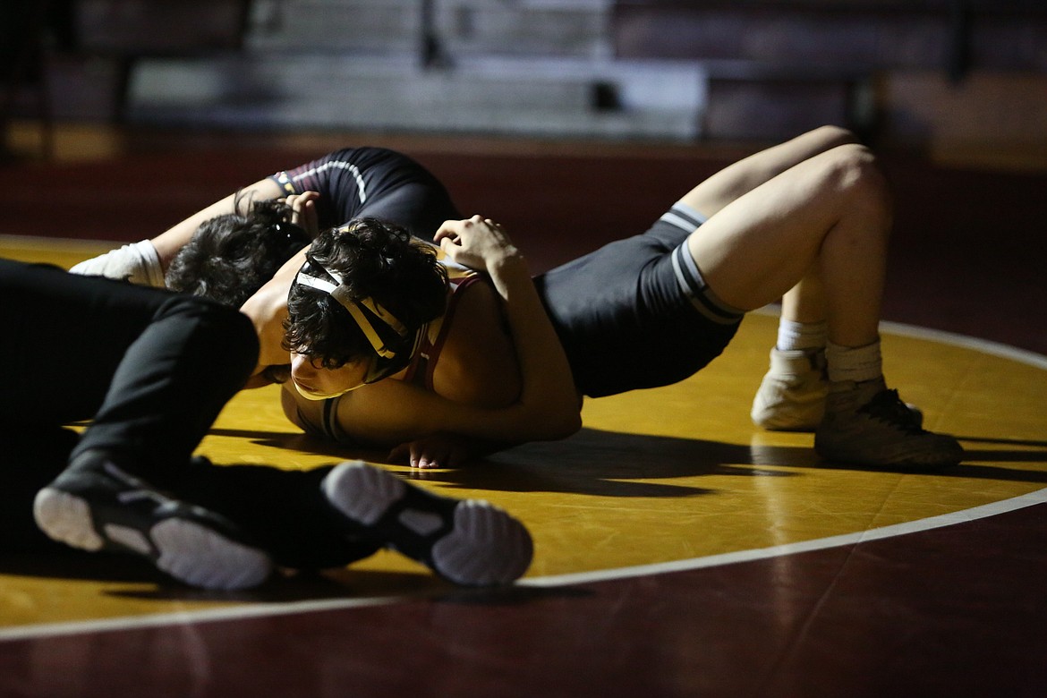 Moses Lake sophomore Ian Garza, top, began Wednesday’s dual with a pin over Othello junior Christopher Garcia in the 106-pound bracket.