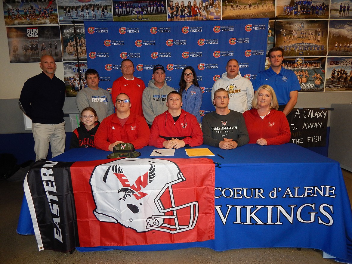 Courtesy photo
Coeur d'Alene High senior Shea Robertson recently signed a letter of intent to play football at Eastern Washington University. Seated are Shea Robertson, center, and family; and standing from left, Josh Potter, Coeur d'Alene High assistant football coach; Vinny Lupinacci, Coeur d'Alene High assistant football coach; Shea Robertson (dad); Shawn Amos, Coeur d'Alene High head football coach; Victoria Beecher, Coeur d'Alene High athletic director; Brian Holgate, Coeur d'Alene High assistant football coach; and Dylan Franks, Coeur d'Alene High assistant football coach.