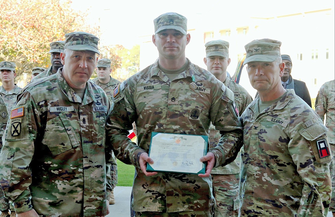 Command Sgt. Maj. Jerry Higley, the 188th Infantry Brigade senior enlisted advisor, left, and 188th Infantry Brigade Commander Col. William Shoemate, right, poses for a photo with Staff Sgt. Adam Vissia after the all-wheel vehicle mechanic received an Army Commendation Medal at a Dec. 15 ceremony at Fort Stewart. Vissia earned the award after taking heroic action during a vehicle accident in August, resulting in saving a soldier's life.